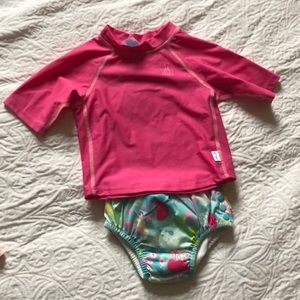 Two piece rash guard. Bottoms are swim diaper.